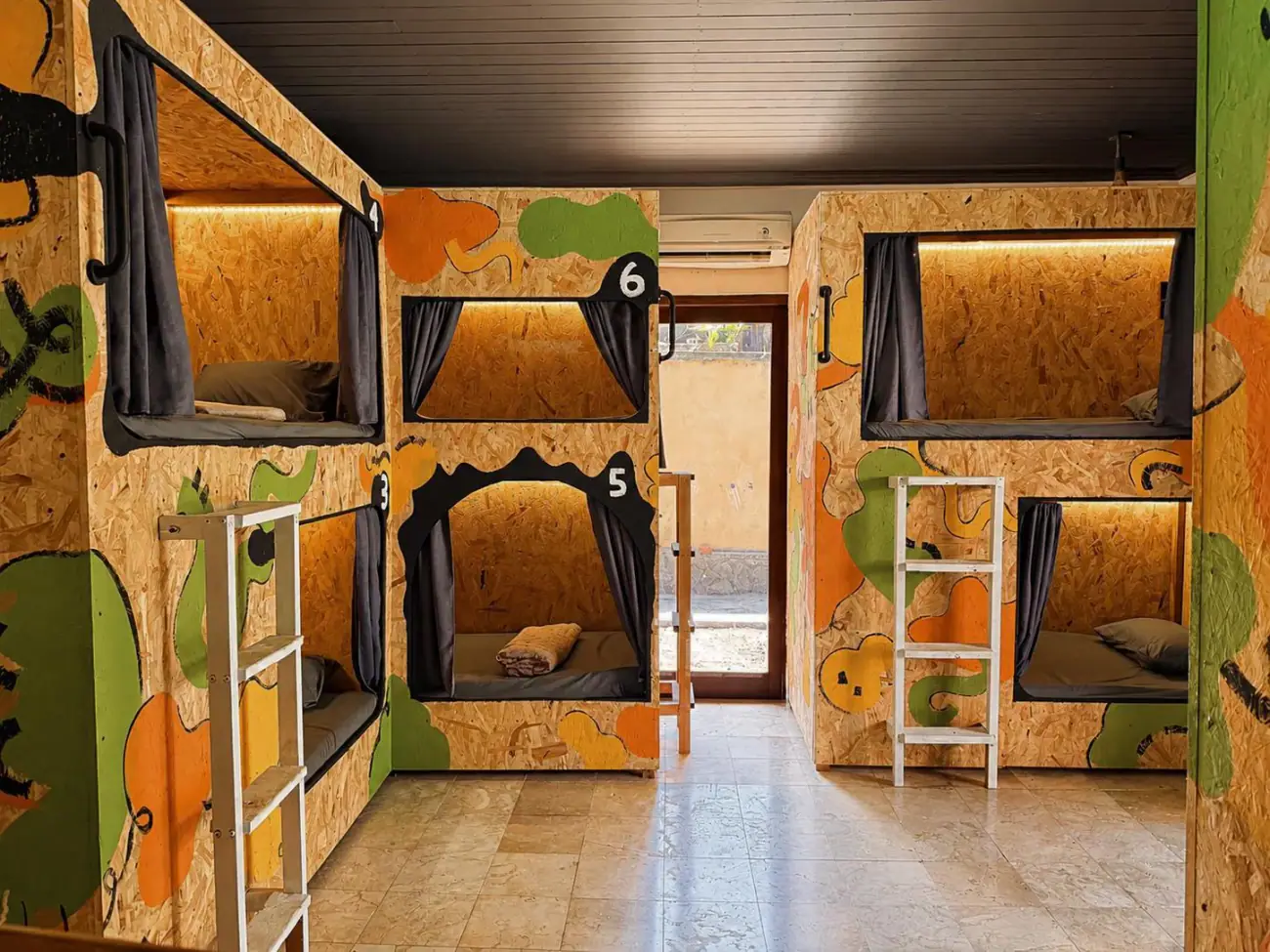 The 10-bed dorm, pods painted orange and green